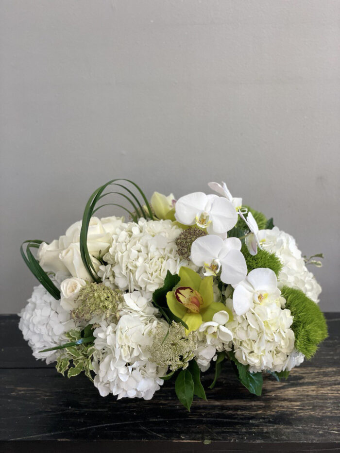 White and Green flower arrangement with hydrangeas and orchids